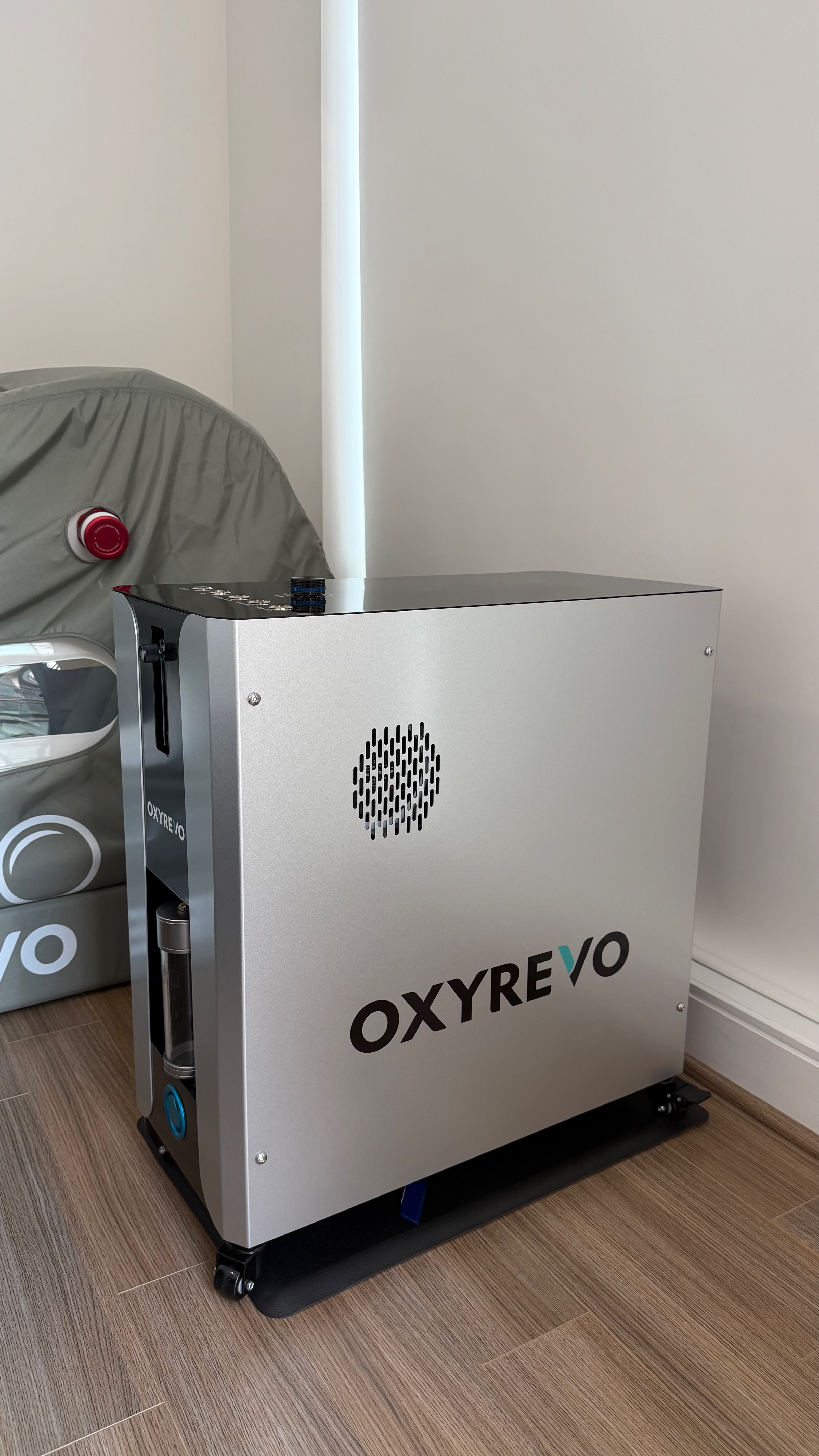 Used hyperbaric chamber Atlanta — OXYREVO Forward90 Pro Version all-in-one operating unit shown beside the sage green Forward90 chamber. Actual unit photo from the original owner's Buckhead, Atlanta GA home, included with this private-sale used hyperbaric chamber for local pickup.